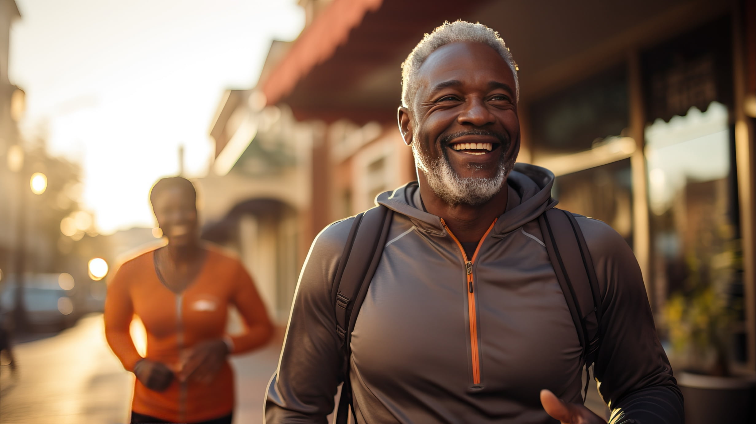 Two smiling middle-aged people jogging